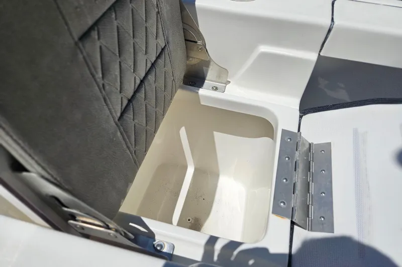Slide: The Image of Storage compartment in 2022 Sea Pro 228 Bay boat with cushioned seat and metal hinge. - 17