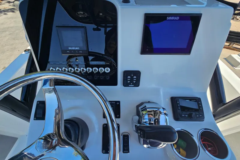 Slide: The Image of Steering console of 2022 Sea Pro 228 Bay boat with navigation and control systems. - 19
