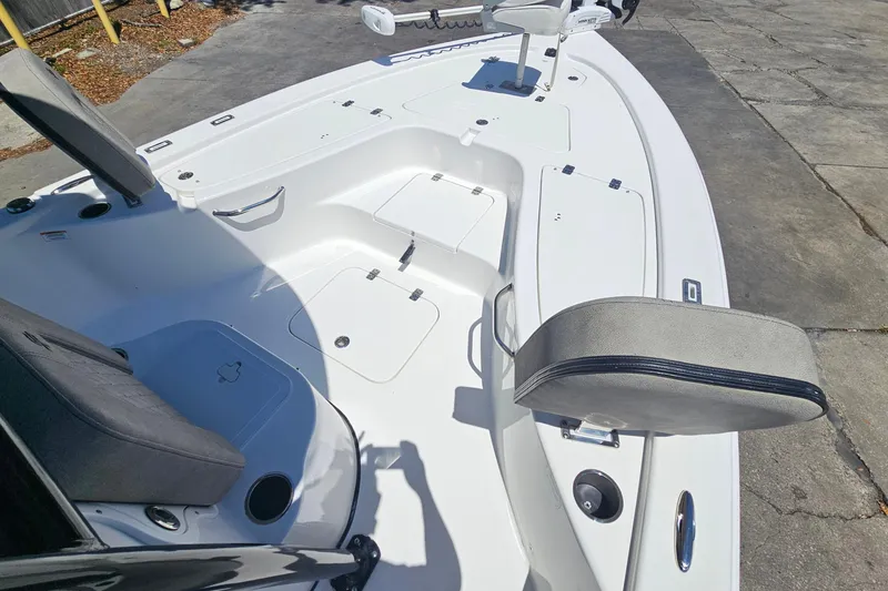 Slide: The Image of 2022 Sea Pro 228 Bay boat deck with seating and storage compartments. - 21