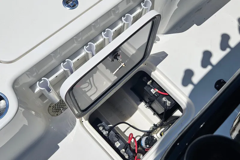 Slide: The Image of 2022 Sea Pro 228 Bay boat battery compartment with rod holders and wiring. - 22