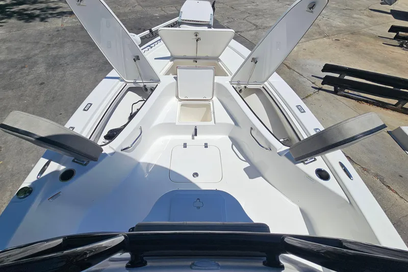 Slide: The Image of 2022 Sea Pro 228 Bay boat with open storage compartments on deck. - 24