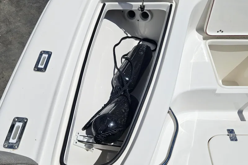 Slide: The Image of Storage compartment on a 2022 Sea Pro 228 Bay boat with black fender. - 26