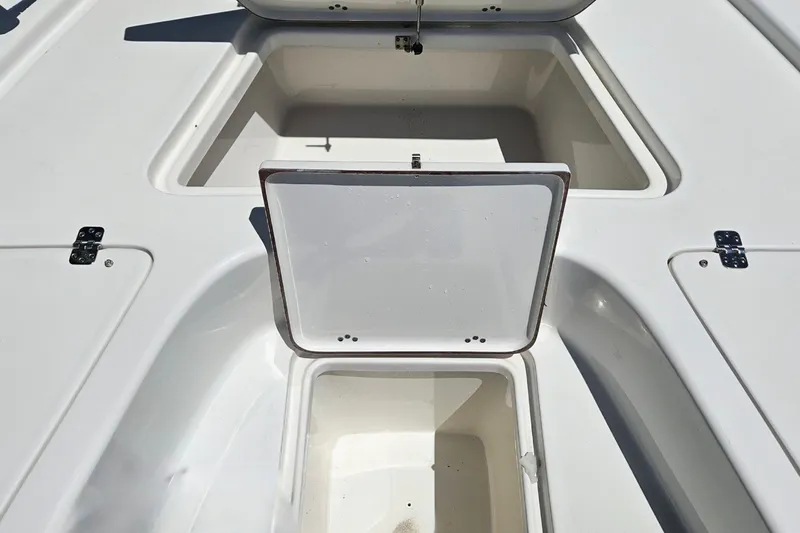 Slide: The Image of Open storage compartments on a 2022 Sea Pro 228 Bay boat deck. - 27