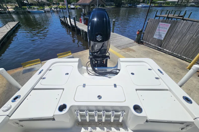 Slide: The Image of 2022 Sea Pro 228 Bay boat at dock, featuring a powerful outboard motor. - 28