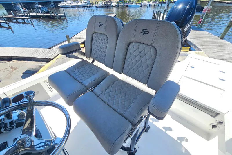 Slide: The Image of 2022 Sea Pro 228 Bay boat seats with diamond stitching, docked by the water. - 29