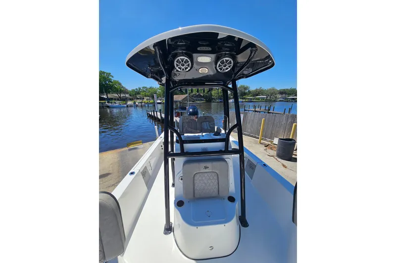 Slide: The Image of 2022 Sea Pro 228 Bay boat docked by a serene waterfront. - 32