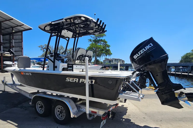 Slide: The Image of 2022 Sea Pro 228 Bay boat with Suzuki engine on trailer by waterfront. - 6