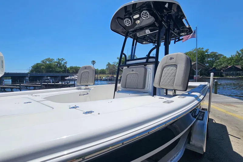 Slide: The Image of 2022 Sea Pro 228 Bay boat docked, featuring sleek design and comfortable seating. - 9