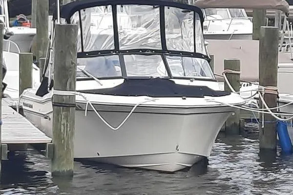 Slide: The Image of 2016 Grady-White Freedom 205 boat docked at marina, covered with black canopy. - 12