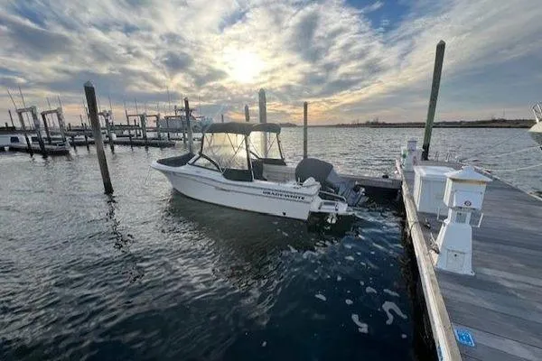 Slide: The Image of 2016 Grady-White Freedom 205 boat docked at marina during sunset. - 14
