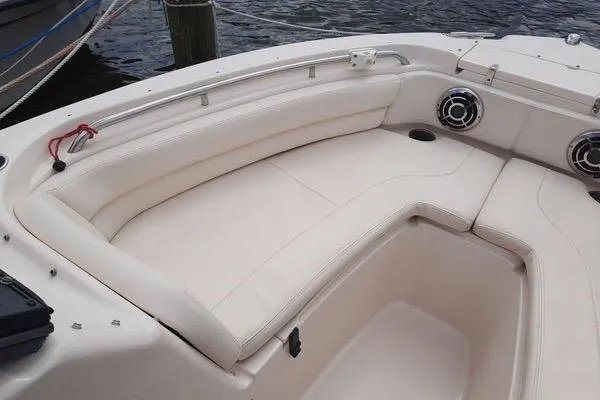 Slide: The Image of 2016 Grady-White Freedom 205 boat interior with white seating and speakers. - 24