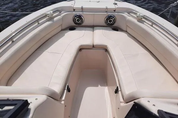 Slide: The Image of 2016 Grady-White Freedom 205 boat interior with cushioned seating and speakers. - 25