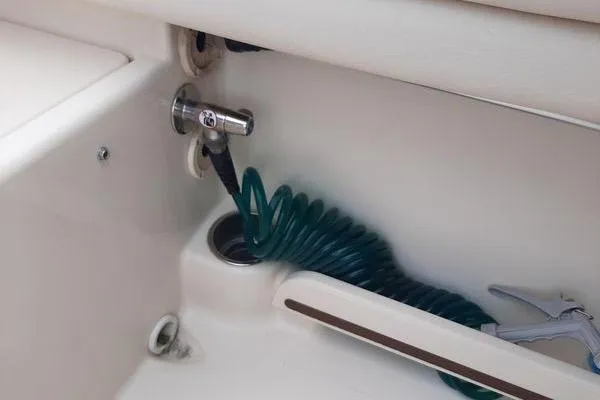 Slide: The Image of Coiled hose in 2016 Grady-White Freedom 205 boat interior. - 26