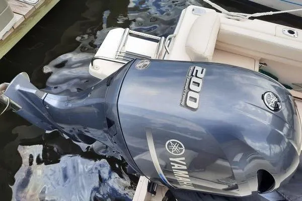 Slide: The Image of 2016 Grady-White Freedom 205 boat with Yamaha 200 outboard motor, docked by water. - 27