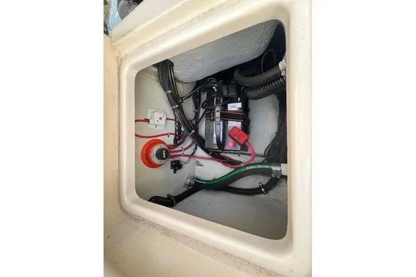 Slide: The Image of 2016 Grady-White Freedom 205 boat battery compartment with wiring and components. - 29