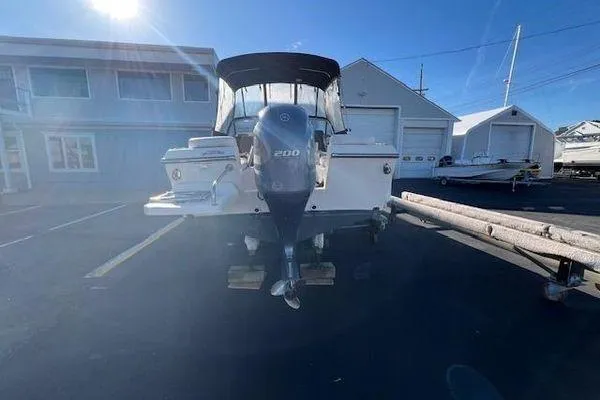 Slide: The Image of 2016 Grady-White Freedom 205 boat with 200 HP engine in a marina setting. - 33