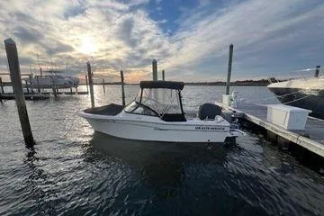 Slide: The Image of 2016 Grady-White Freedom 205 boat docked at marina during sunset. - 5