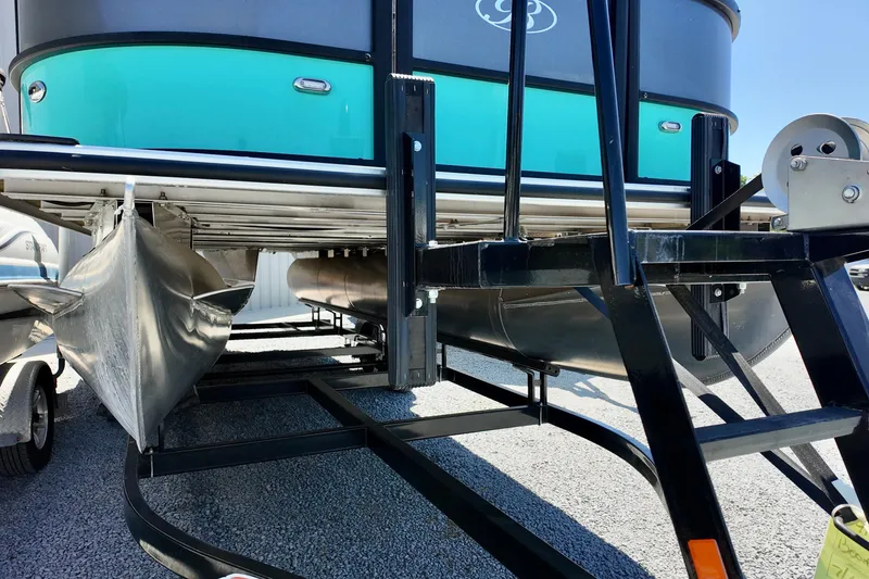 Slide: The Image of 2024 Bentley Pontoons 24 Legacy on trailer, showcasing pontoon structure and design. - 10