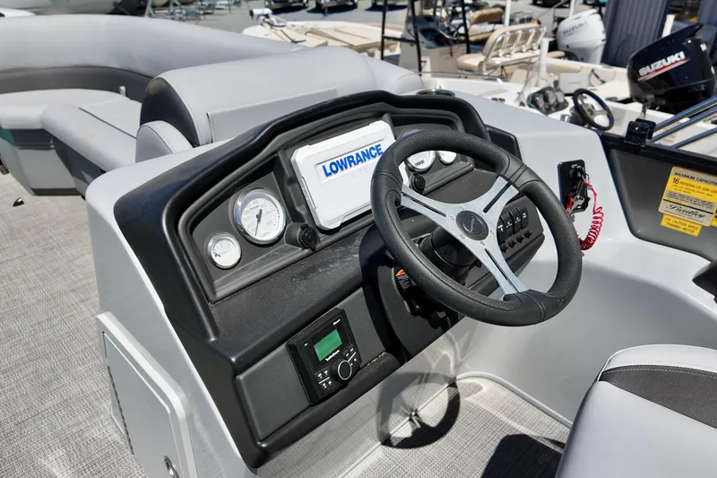 Slide: The Image of 2024 Bentley Pontoons 24 Legacy dashboard with steering wheel and navigation system. - 7