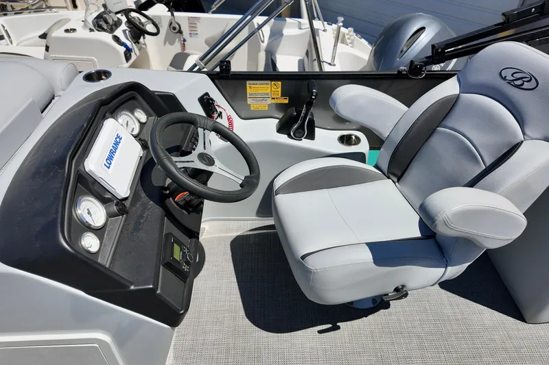 Slide: The Image of 2024 Bentley Pontoons 24 Legacy helm with steering wheel and comfortable captain's chair. - 8