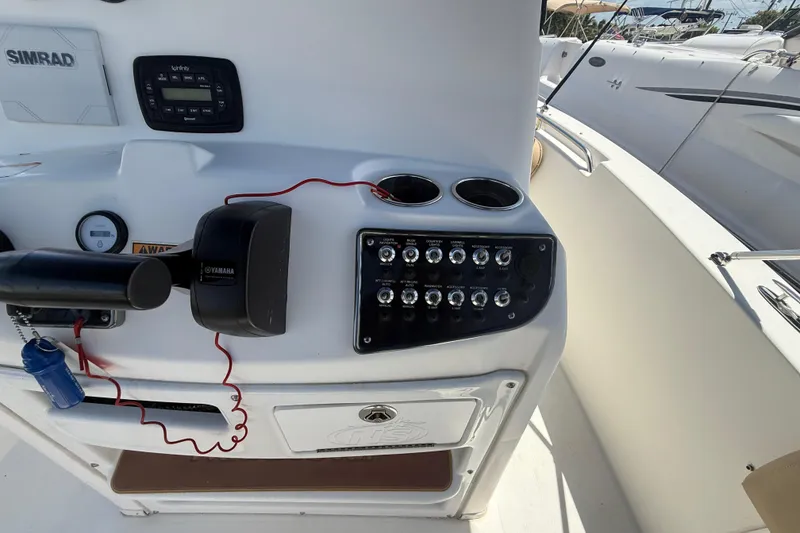 Slide: The Image of 2019 NauticStar 2102 Legacy boat console with steering wheel and seating. - 11