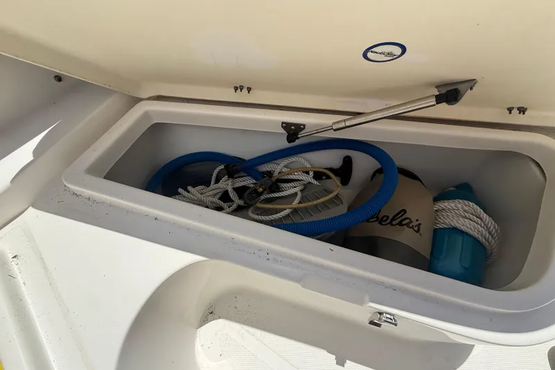 Slide: The Image of 2019 NauticStar 2102 Legacy boat with logo, docked on land. - 19