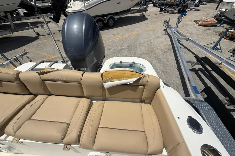 Slide: The Image of 2019 NauticStar 2102 Legacy boat with Yamaha engine and damaged seat upholstery. - 5