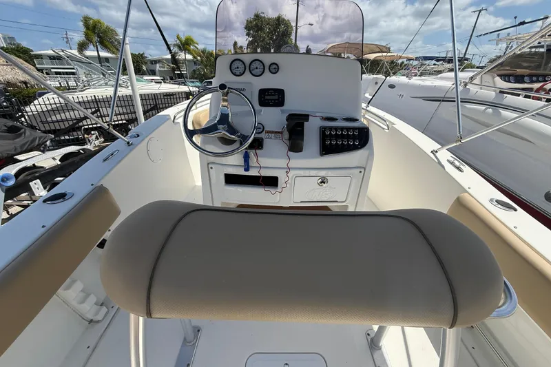 Slide: The Image of Control panel of a 2019 NauticStar 2102 Legacy boat with switches and gauges. - 9