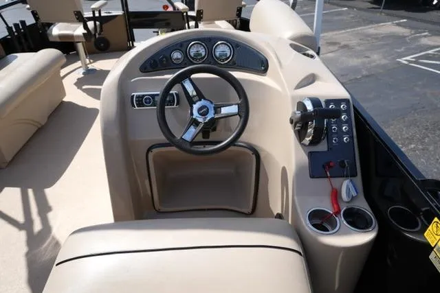 Slide: The Image of Steering console of a 2017 Bentley 244 boat with beige interior and control panel. - 11