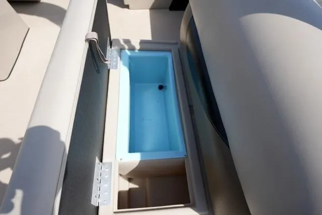 Slide: The Image of 2017 Bentley 244 boat seat storage compartment with open lid, revealing a blue interior. - 13