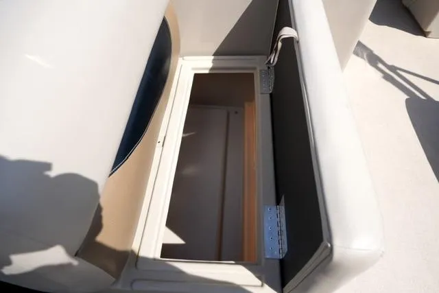 Slide: The Image of 2017 Bentley 244 boat seat storage compartment open, showcasing interior space. - 15