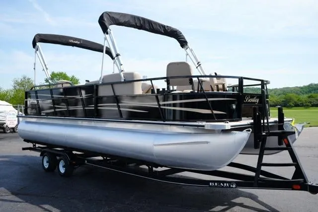 Slide: The Image of 2017 Bentley 244 pontoon boat on trailer, featuring dual bimini tops and sleek design. - 3