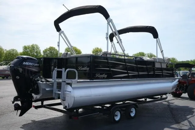 Slide: The Image of 2017 Bentley 244 pontoon boat with Mercury engine on trailer, parked outdoors. - 5