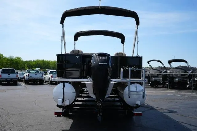 Slide: The Image of 2017 Bentley 244 pontoon boat with canopy and outboard motor in parking lot. - 6