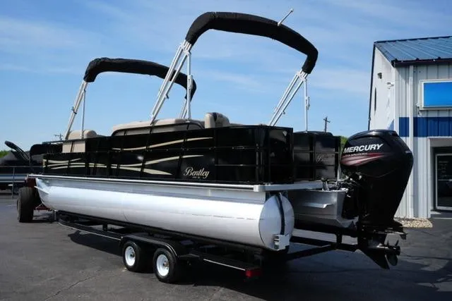 Slide: The Image of 2017 Bentley 244 pontoon boat with Mercury engine on trailer, parked outside a building. - 7