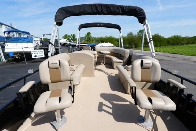 Slide: The Image of 2017 Bentley 244 pontoon boat with beige seating and canopy, docked outdoors. - 8