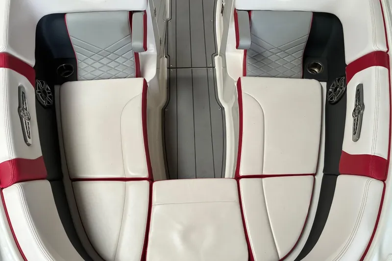 Slide: The Image of 2020 Chaparral 25 Surf boat interior with red and white seating and modern design. - 10
