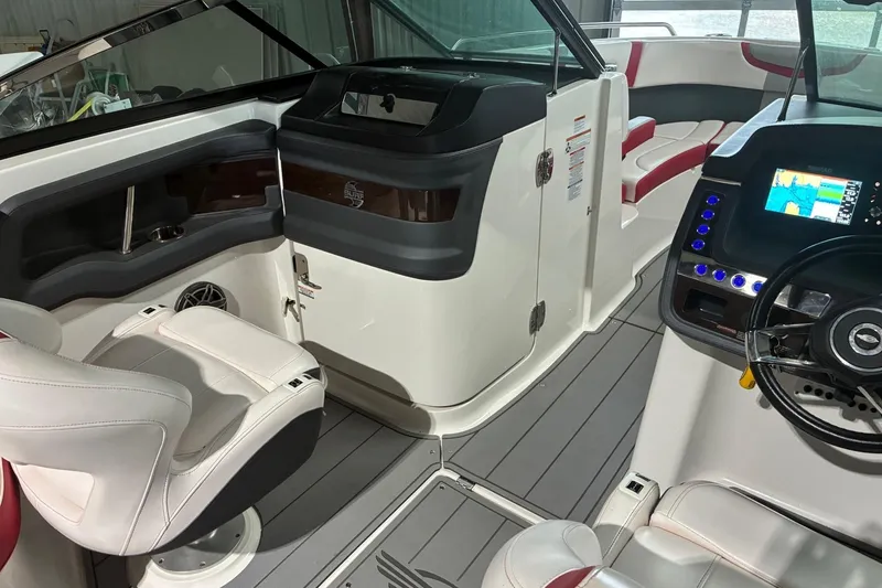 Slide: The Image of 2020 Chaparral 25 Surf boat interior with modern dashboard and seating. - 12