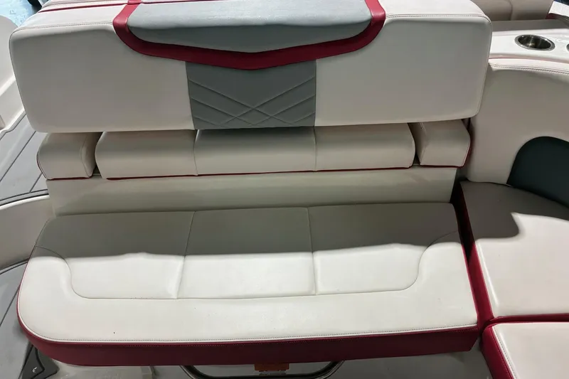 Slide: The Image of 2020 Chaparral 25 Surf boat interior seating with red and gray accents. - 16