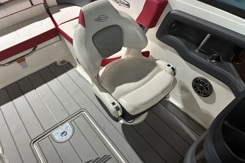 Slide: The Image of 2020 Chaparral 25 Surf boat interior with white and red seating, gray flooring, and speaker. - 20