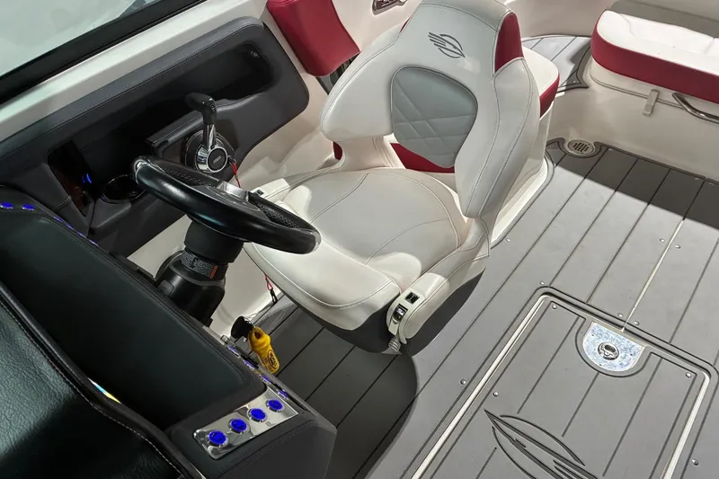 Slide: The Image of Interior of 2020 Chaparral 25 Surf boat with steering wheel and seating. - 21