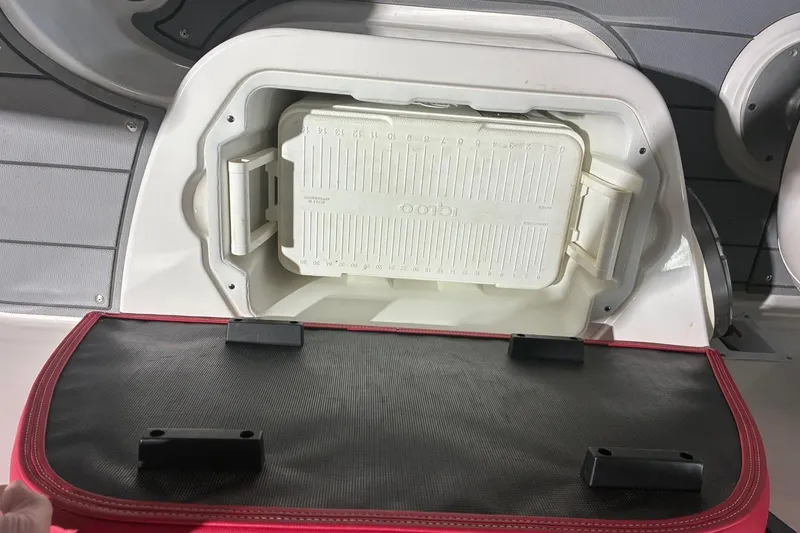 Slide: The Image of Storage compartment in a 2020 Chaparral 25 Surf boat with cooler inside. - 27