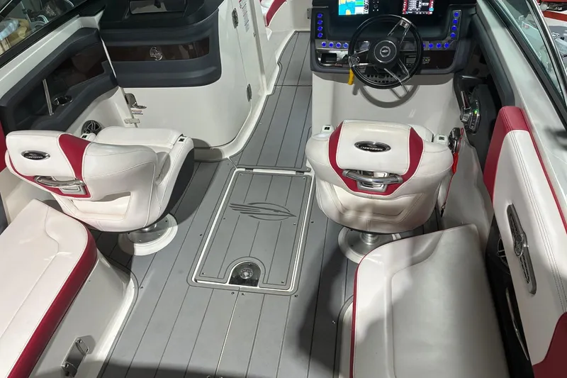 Slide: The Image of 2020 Chaparral 25 Surf boat interior with modern dashboard and white-red seating. - 28