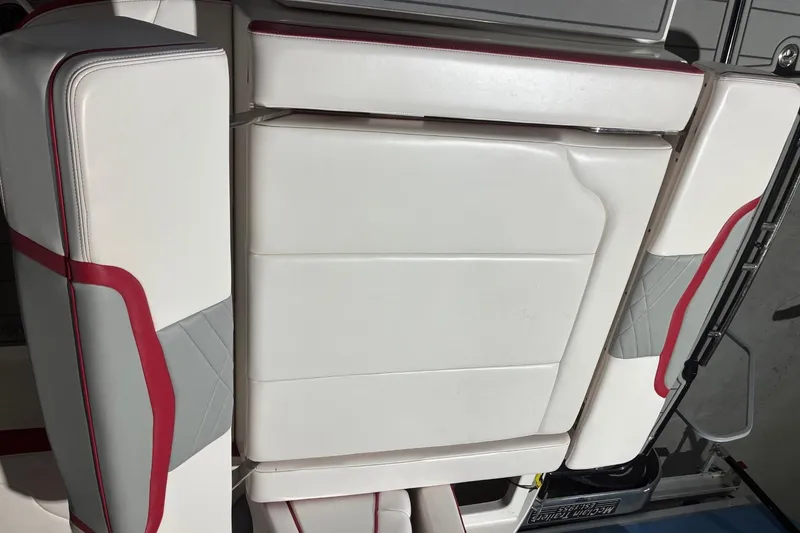 Slide: The Image of 2020 Chaparral 25 Surf boat interior seating with red and gray accents. - 29