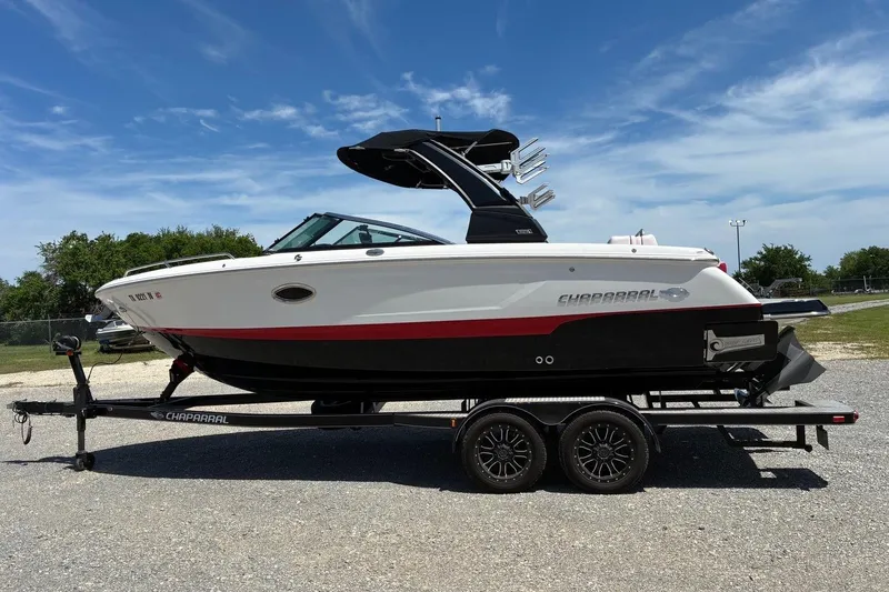Slide: The Image of 2020 Chaparral 25 Surf boat on trailer under clear blue sky. - 3