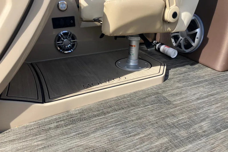 Slide: The Image of 2023 Godfrey Monaco 255 SB boat interior with beige seating and speaker system. - 12