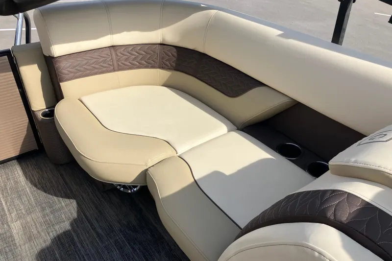Slide: The Image of Luxurious seating on 2023 Godfrey Monaco 255 SB boat, featuring beige and brown upholstery. - 13