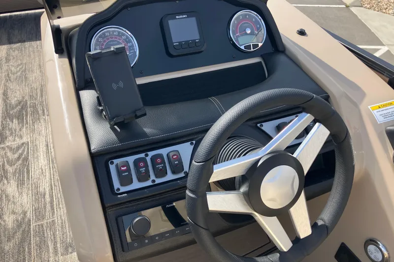 Slide: The Image of Steering console of 2023 Godfrey Monaco 255 SB boat with modern controls and gauges. - 16