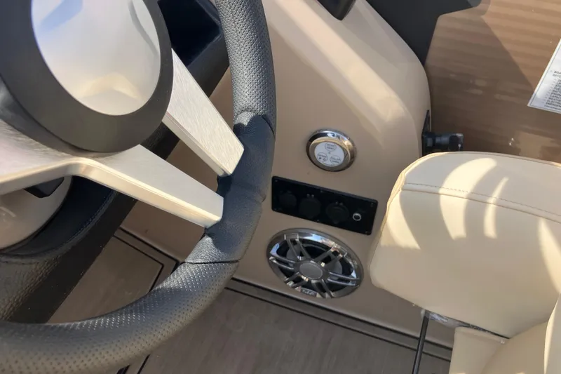 Slide: The Image of Steering wheel and controls of 2023 Godfrey Monaco 255 SB boat interior. - 17