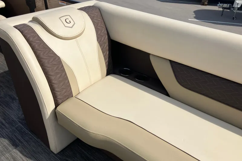 Slide: The Image of Luxurious seating on 2023 Godfrey Monaco 255 SB boat, featuring elegant beige and brown upholstery. - 23